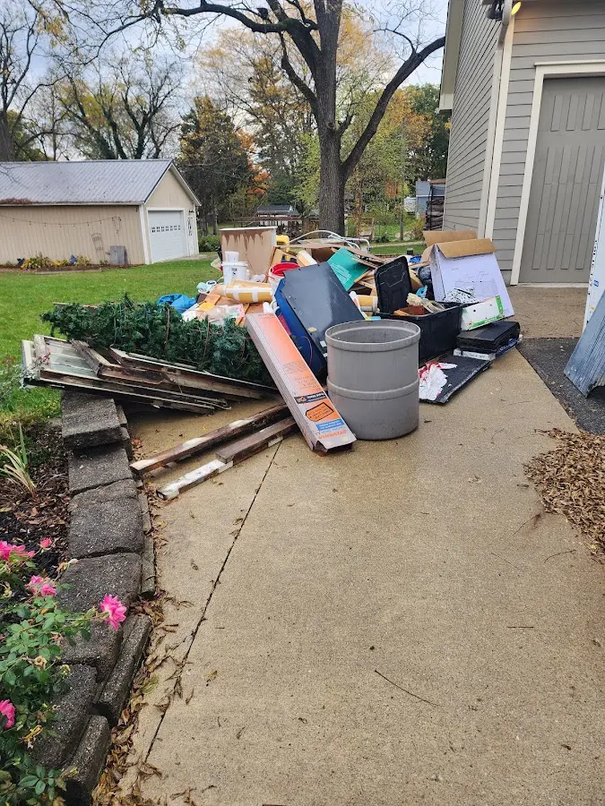 Dumpster being loaded with debris for 12 Yard Dumpster Rental in Artondale